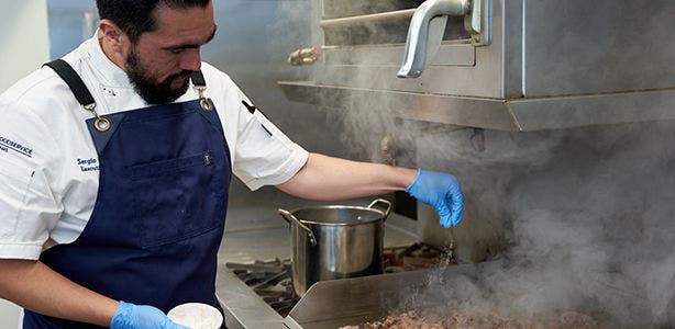 Chef cooking on stove.