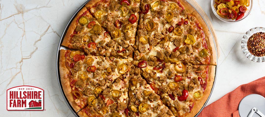 Large sausage pizza with cheese and various ingredients 