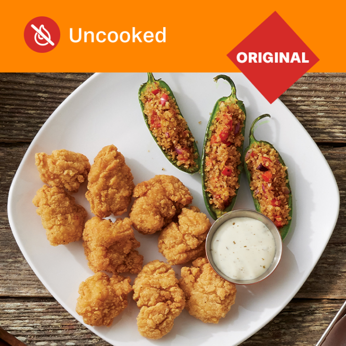 Tyson Red Label® Authentically Crispy Original Chicken Chunks on a plate with a side of jalapeño poppers