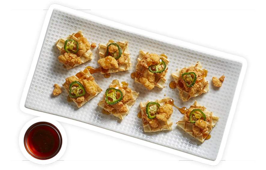 Bite-sized, mini chicken waffles with a hot-honey glaze and candied jalapeños