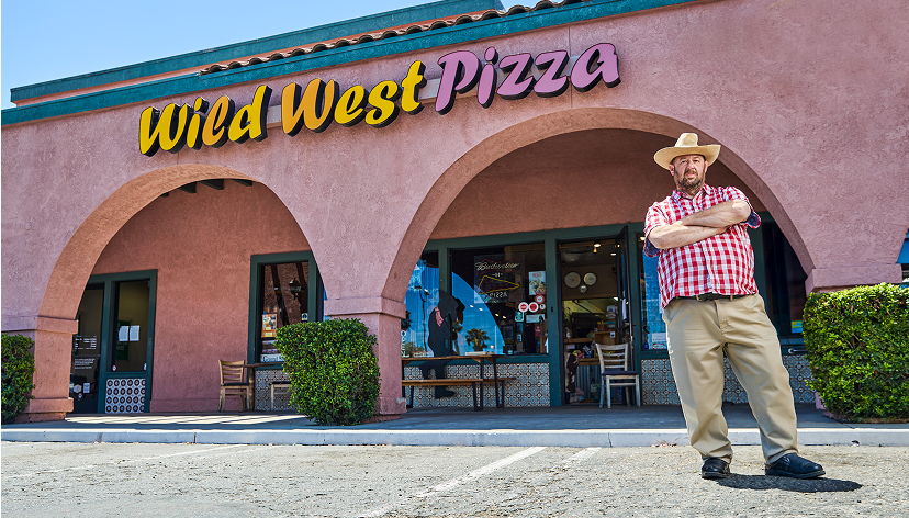 Wild west pizza restaurant with the owner standing infront