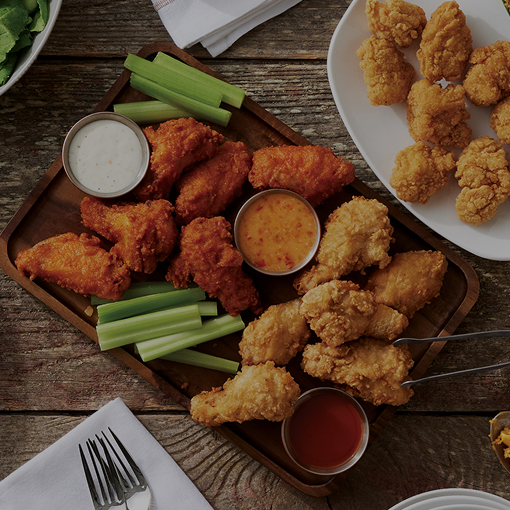 bone-in wings on a platter with sauce