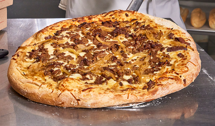 entrée featuring Steak-EZE® Redi-Steak® Fully Cooked Seasoned Sliced Beef in restaurant setting