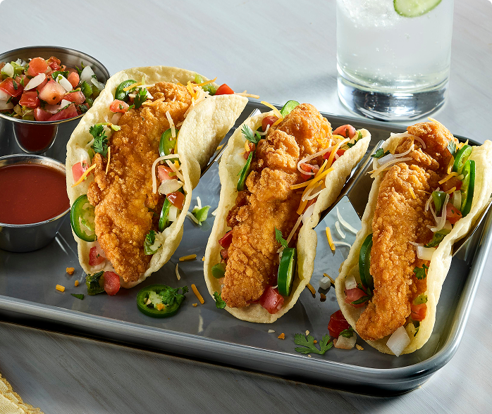 3 gluten-free chicken tenderloin tacos in a crispy tortilla with cheese, pico de gallo and jalapeño