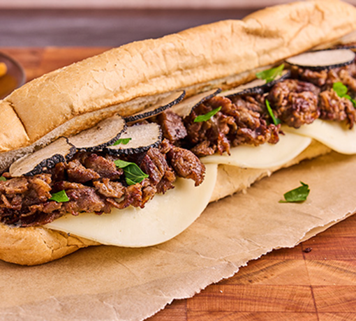 Shaved steak, truffle aioli, provolone cheese, and shaved black truffles served on a hoagie bun.