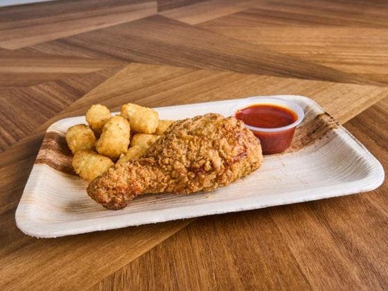 Breaded drumstick served with Nashville Hot Apricot Honey Sauce for a spicy-sweet Southern-style kick.