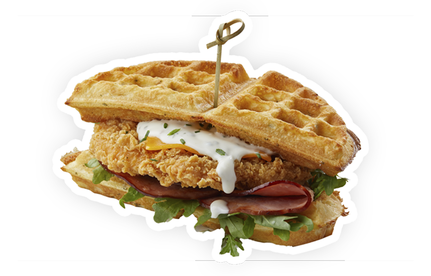 A plate featuring a chicken waffle sandwich, avocado and a soft-boiled egg