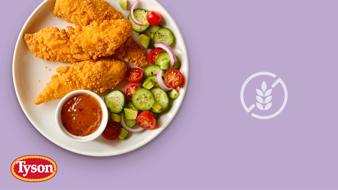 Tyson gluten free chicken strips on a white plate with sides