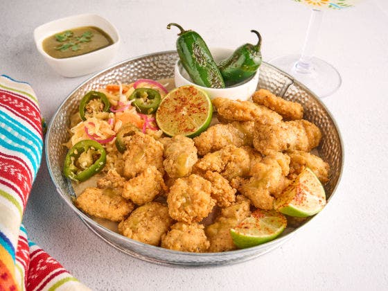 Crispy boneless wings drizzled with jalapeño lime butter, served with Salvadoran-style slaw