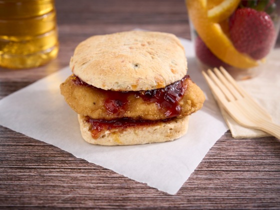 Chicken sandwich with strawberry chipotle jam on parchment paper