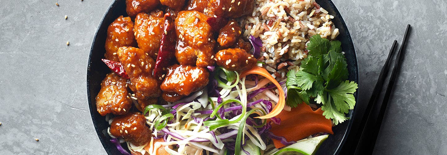 Rice and spicy chicken bowl with sprouts.