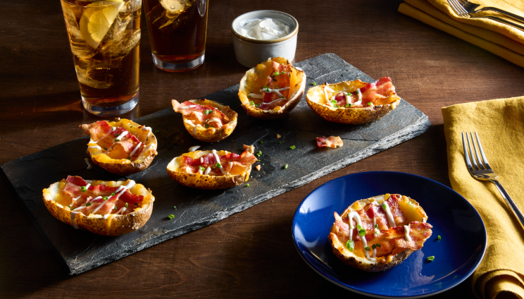 potato skins with bacon inside on a grey serving tray