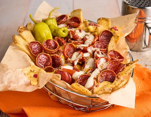 Fries topped with pepperoni, queso, and ranch dressing, served with pepperoncini peppers on the side