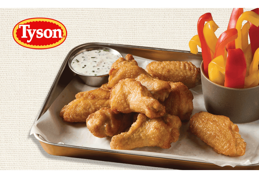Tyson logo above a tray of golden bone-in chicken wings served with creamy dipping sauce and sliced red and yellow bell peppers
