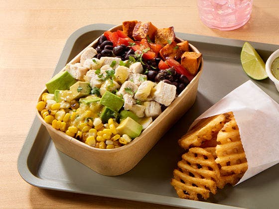 Bowl with grilled chicken, roasted sweet potato, red pepper, black beans, avocado, corn, and lime vinaigrette