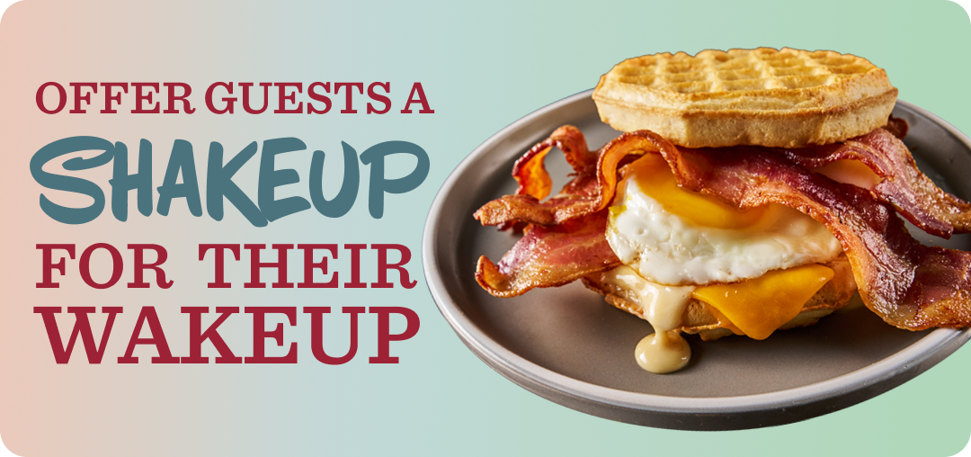 A plate with an egg, cheese, bacon and sauce served sandwiched between two waffles 