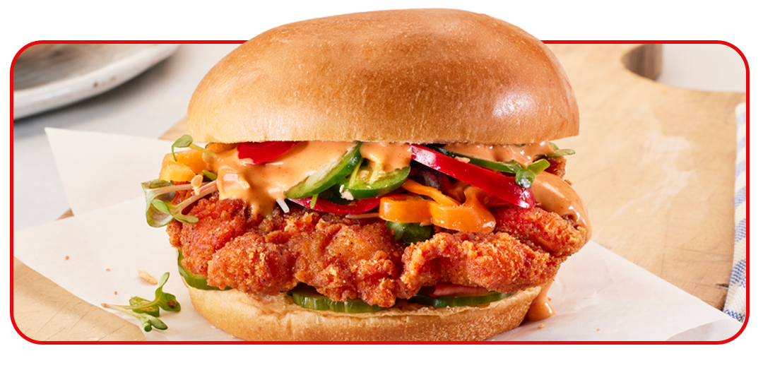 Sandwich and side of potato chips on table setting