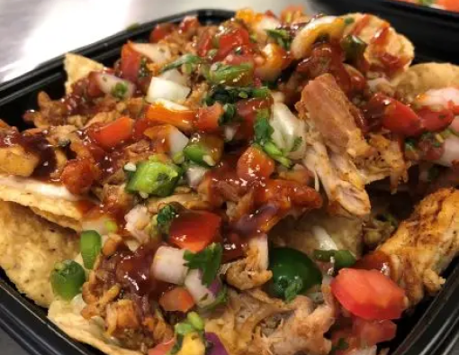 To-go container filled with pulled Jerk chicken, jalapeños, corn and Pico de Gallo 