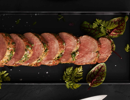 Herbed Honey Mustard Roast Pork Tenderloin Sliced and Layered on a Plate