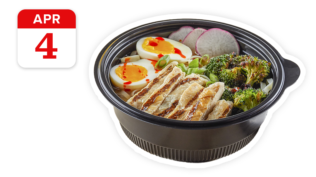 bowl of ramen with chicken and hard broiled eggs, plus broccoli, radish, green scallion onions and hot sauce