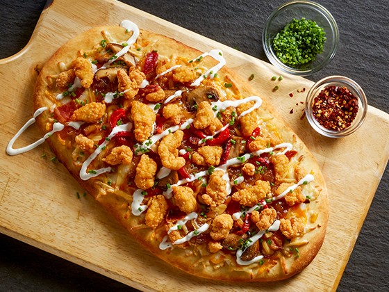 Tyson® Mini Chicken Bites served on a sweet and savory Chicken Bacon and Ranch Flatbread.