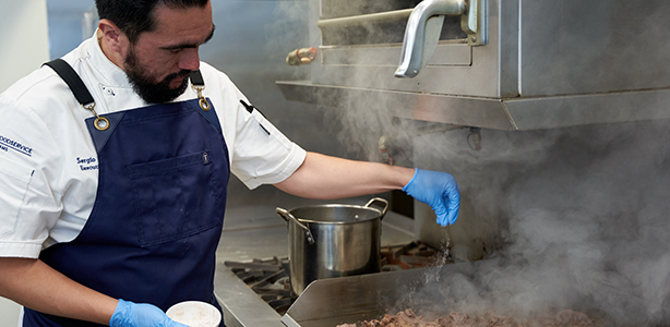 Chef preparing food in an industrial kitchen